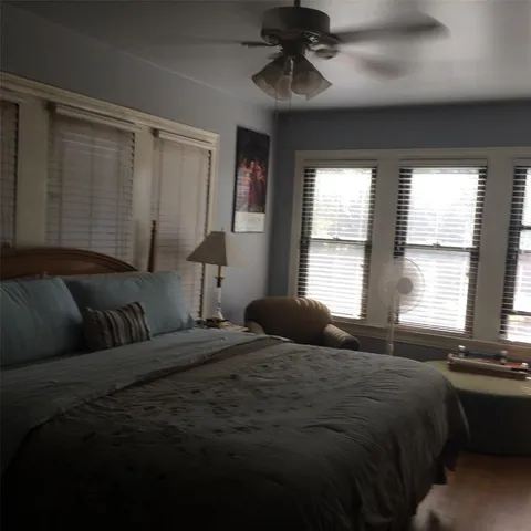 a bedroom with a large bed and a window