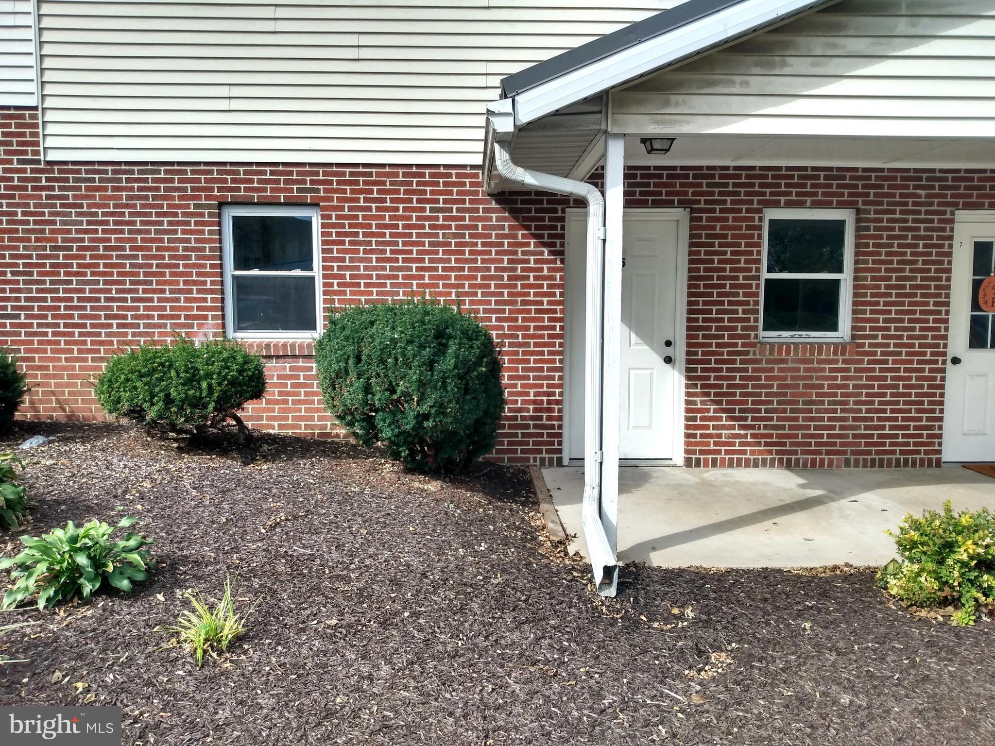 861 Buchanan Trail East, Unit 5 Greencastle, PA 17225 - Photo 2 of 14 a front view of a house with garden
