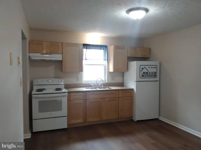 a kitchen with stainless steel appliances granite countertop a stove and a refrigerator