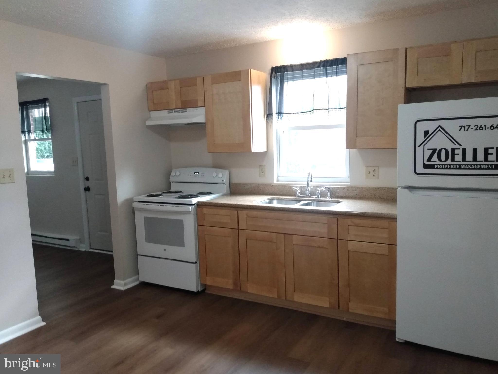 861 Buchanan Trail East, Unit 5 Greencastle, PA 17225 - Photo 5 of 14 a kitchen with granite countertop white cabinets and white appliances