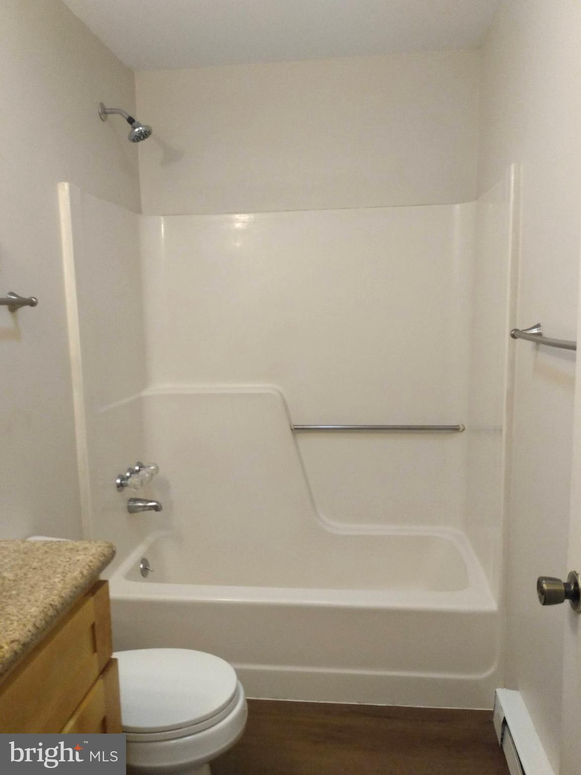 861 Buchanan Trail East, Unit 5 Greencastle, PA 17225 - Photo 10 of 14 a bathroom with a granite countertop bathtub shower sink vanity and toilet