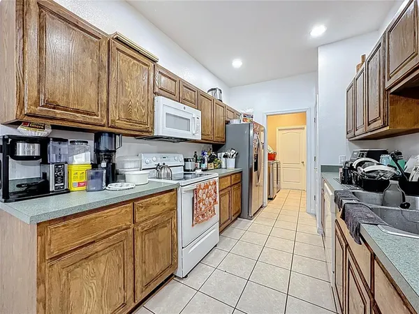 a kitchen with stainless steel appliances granite countertop a sink and cabinets