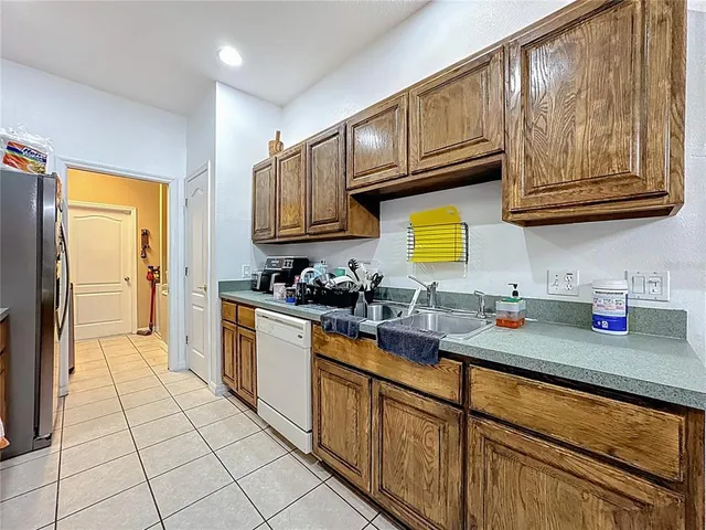 a kitchen with stainless steel appliances granite countertop a sink dishwasher stove and cabinets