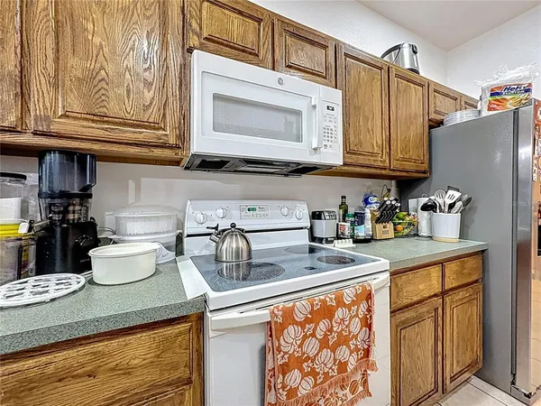 a kitchen with stainless steel appliances granite countertop a sink dishwasher and cabinets with wooden floor
