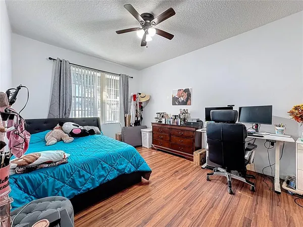 a bedroom with a bed and wooden floor
