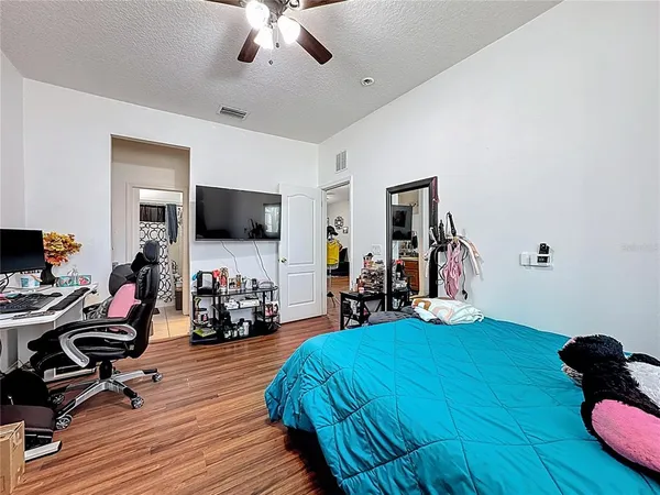 a bed room with furniture and a flat screen tv