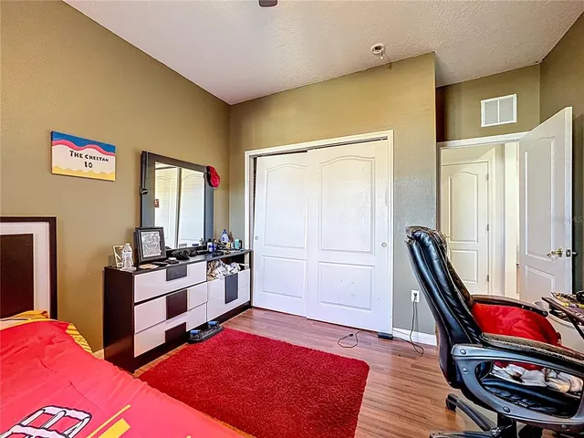 a living room with stainless steel appliances furniture and a rug