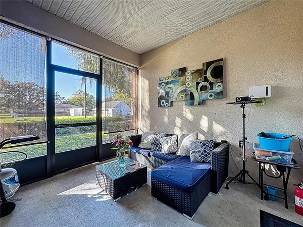a living room with furniture and a floor to ceiling window