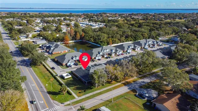 an aerial view of a house with a mountain