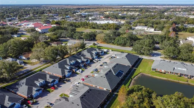 an aerial view of a house with a lake