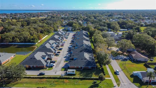an aerial view of a house with a garden and lake view