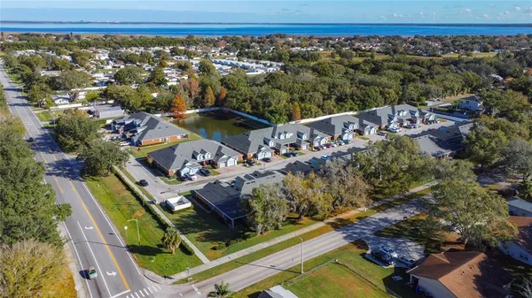 an aerial view of a house with a mountain