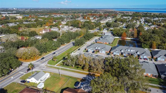 an aerial view of a residential houses with outdoor space and swimming pool