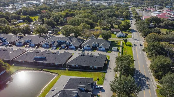 an aerial view of a house with a swimming pool outdoor seating and yard