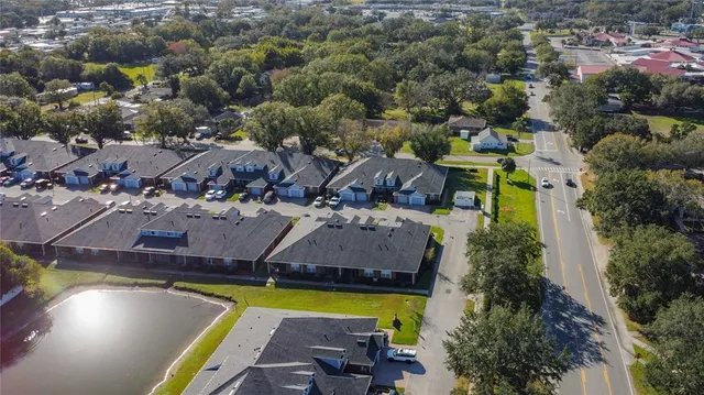 an aerial view of a house with a swimming pool outdoor seating and yard