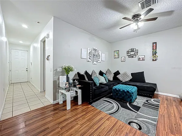 a living room with furniture and wooden floor