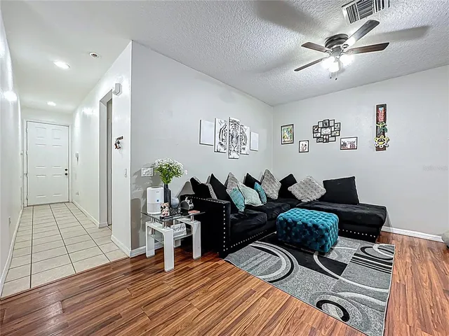 a living room with furniture and wooden floor