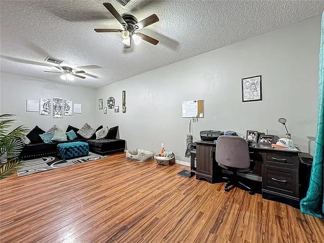 a bedroom with furniture and wooden floor