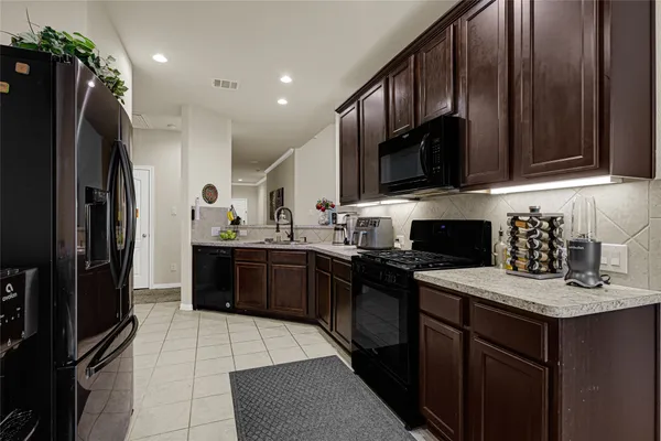 a kitchen with a sink stove and refrigerator