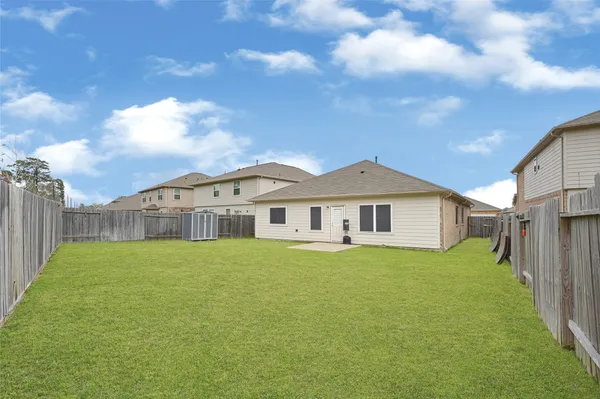 a large house with a big yard and large trees