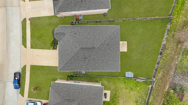 an aerial view of a house with a yard