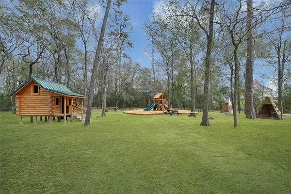 a backyard of a house with childrens swings and slides