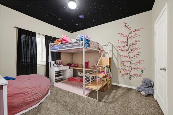 a bedroom with furniture and a flat screen tv