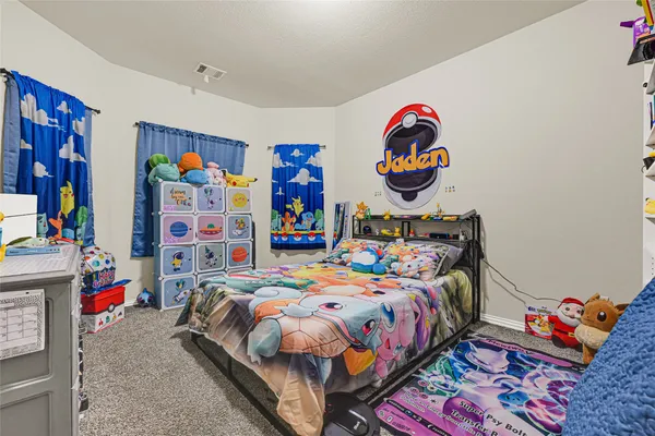 a bedroom with bed and book toys