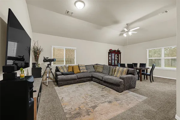 a living room with furniture and a large window