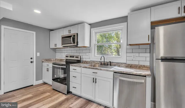 a kitchen with a sink stove and refrigerator