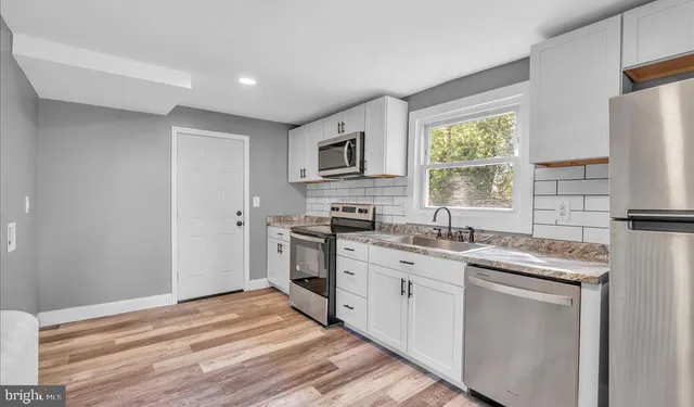 a kitchen with a stove sink and refrigerator