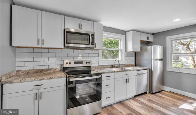 a kitchen with a sink stove and refrigerator