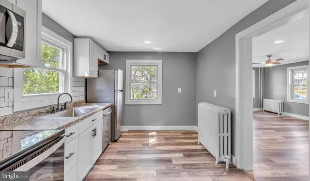 a bathroom with a sink double vanity granite and a window