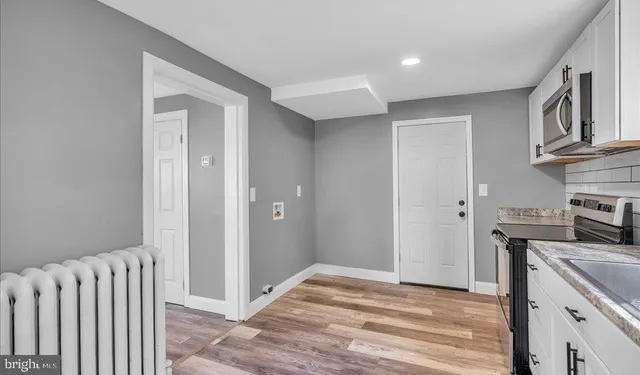 a view of a kitchen with a sink and a refrigerator
