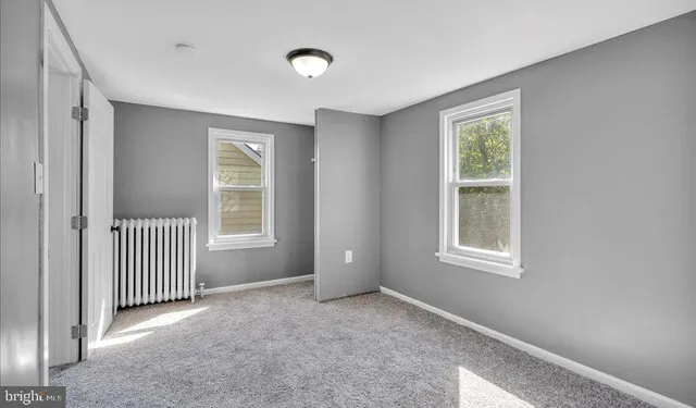 a view of a house with a backyard and a tree