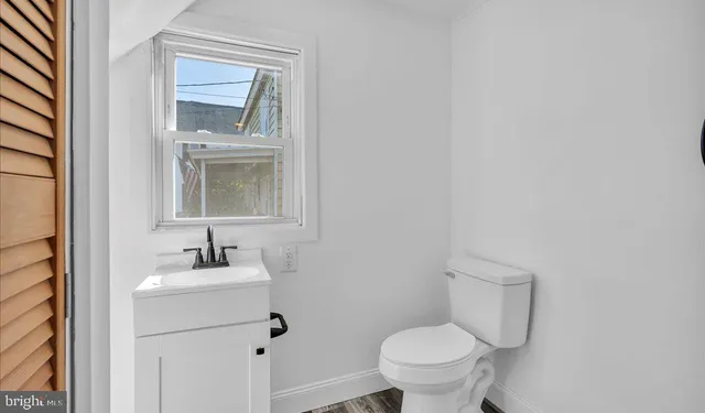 a bathroom with a toilet a sink and mirror