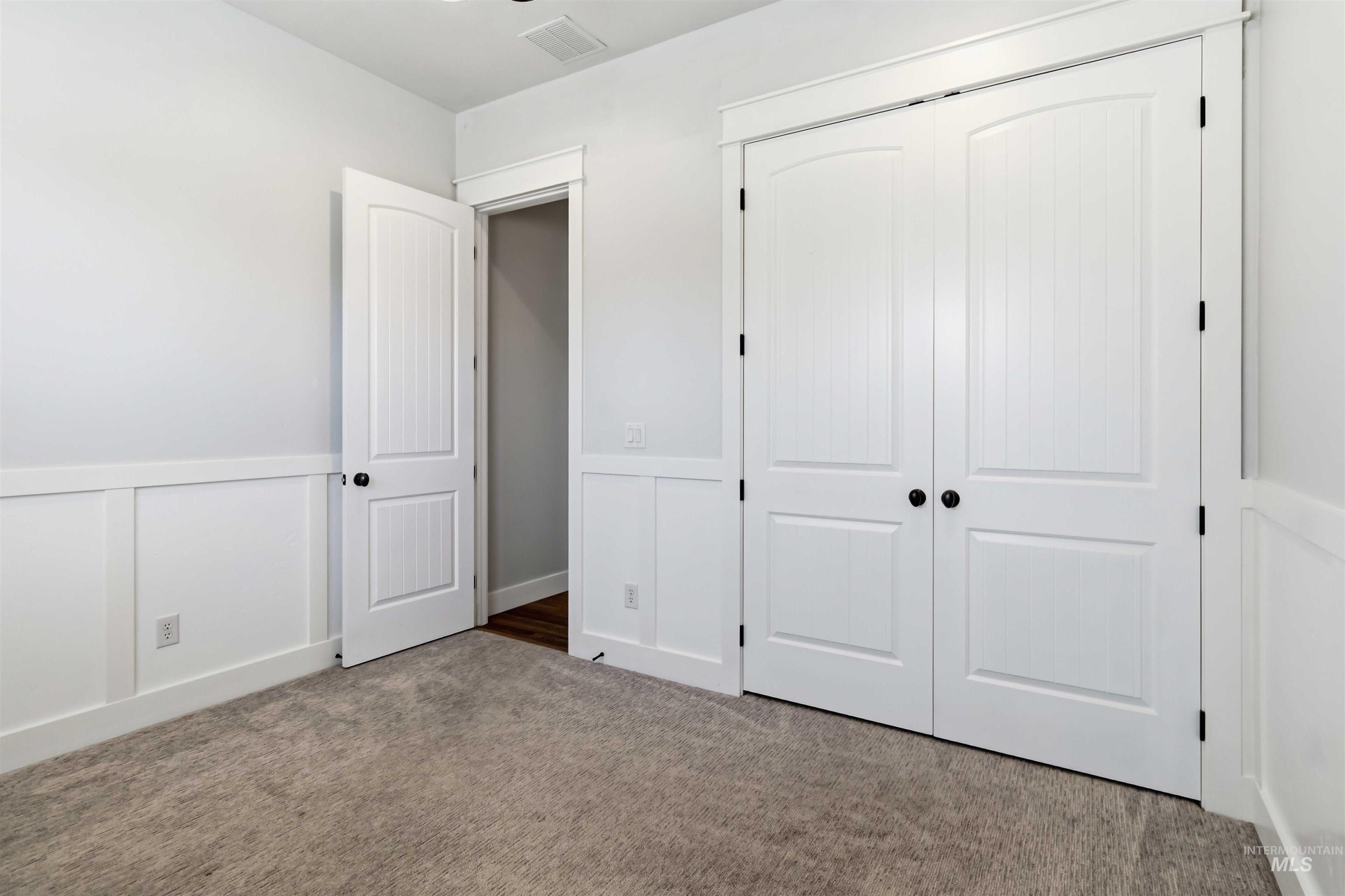 3218 North Cherry Laurel Way Star, ID 83669 - Photo 35 of 50 Interior room featuring neutral wall paint, white wainscoting, and recessed lighting