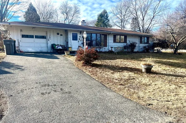 a view of a house with a yard covered in snow