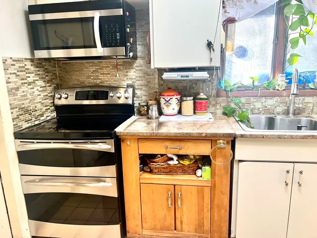 a kitchen with a stove and a microwave