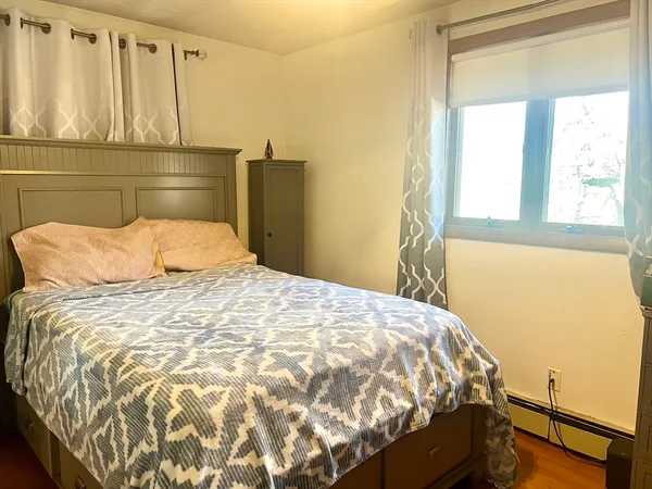 a bedroom with a bed and window