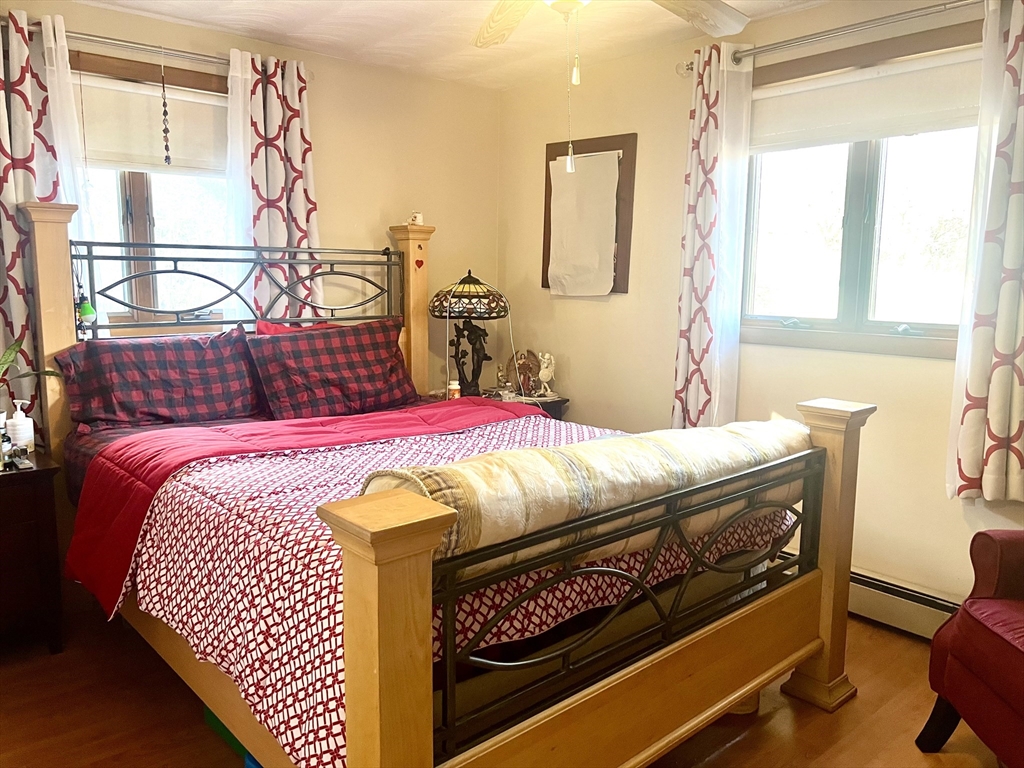 7 Ballydrain Road Framingham, MA 01701 - Photo 5 of 11 a bedroom with a bed a dresser next to a window