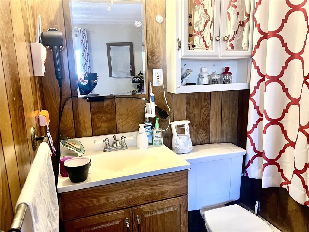 7 Ballydrain Road Framingham, MA 01701 - Photo 7 of 11 a bathroom with a sink a toilet and a mirror