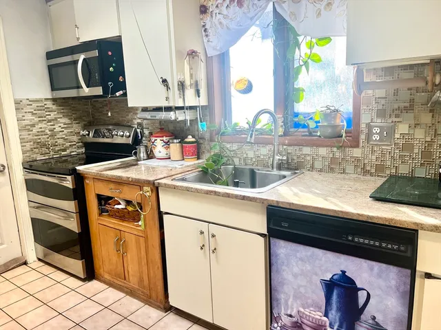 a kitchen with stainless steel appliances granite countertop a sink and a stove
