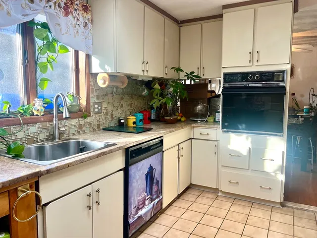 a kitchen with a sink stove and cabinets