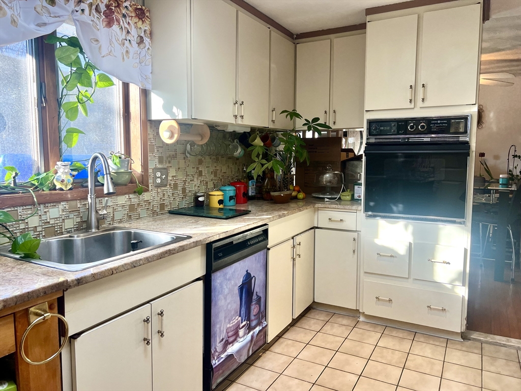 7 Ballydrain Road Framingham, MA 01701 - Photo 10 of 11 a kitchen with a sink stove and cabinets