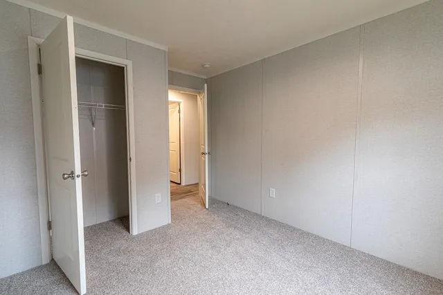 an empty room with closet area