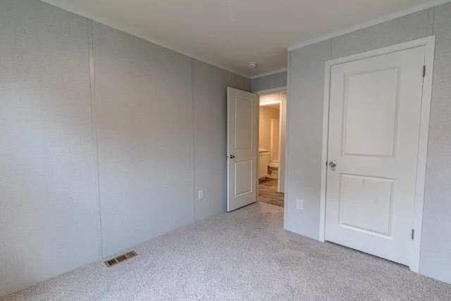 a view of an empty room and closet area