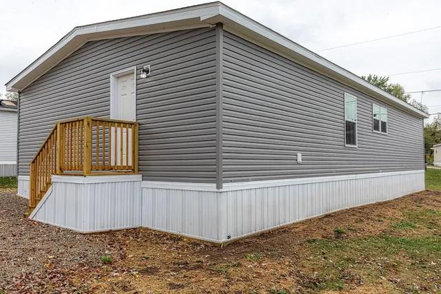 a view of a house with a backyard