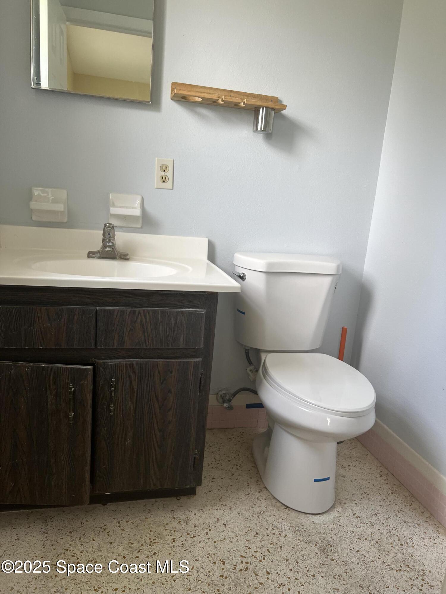 2906 Rollins Street Melbourne, FL 32901 - Photo 11 of 12 a bathroom with a sink and a toilet