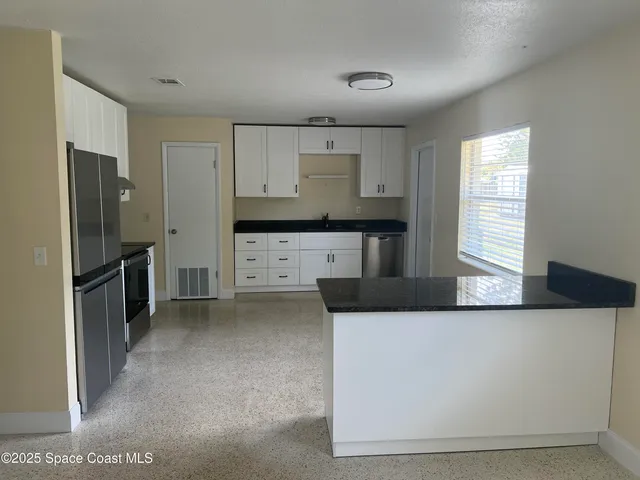 a kitchen with stainless steel appliances a refrigerator sink and stove